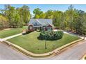 Beautifully landscaped home on a corner lot, surrounded by lush greenery and mature trees at 7804 Gusty Trl, Douglasville, GA 30135