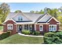 Charming brick home featuring a well-manicured lawn and classic architectural details at 7804 Gusty Trl, Douglasville, GA 30135