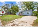 Charming home with well-maintained front lawn, a concrete driveway, and mature trees providing shade at 1623 Athens Sw Ave, Atlanta, GA 30310