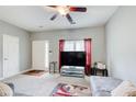 Bright living room with a large TV, a cozy gray couch, and natural light from the front window at 2758 Snapfinger Mnr, Decatur, GA 30035