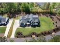 Lovely home with a sprawling green lawn, an estate fence and a long, winding driveway at 120 Farm Gate Dr, Woodstock, GA 30188