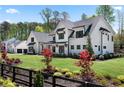 Beautiful home with an attached garage, a large front lawn, and mature landscaping at 120 Farm Gate Dr, Woodstock, GA 30188