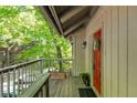 Cozy balcony featuring a vibrant red door and wooden accents, creating a warm and welcoming entrance to the townhome at 2109 Defoors Ferry Nw Rd # D, Atlanta, GA 30318