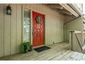 Close-up of a vibrant red front door with decorative details, enhancing the curb appeal of this inviting townhome at 2109 Defoors Ferry Nw Rd # D, Atlanta, GA 30318