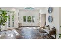 Bright foyer with stone floors, skylight, and grand entry doors offer an open, airy feel with natural light at 5251 Powers Ferry Rd, Atlanta, GA 30327