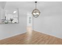 Dining area with hardwood floors, chandelier, and convenient access to the kitchen at 135 Kimbell Farm Dr, Locust Grove, GA 30248