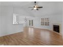Spacious living room features wood floors, a fireplace, and plenty of natural light at 135 Kimbell Farm Dr, Locust Grove, GA 30248