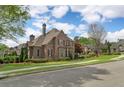 Well-maintained home featuring brick and neutral siding, complemented by lush landscaping at 2114 Castlewycke Ct, Marietta, GA 30068