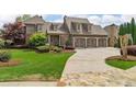 Spacious home with a three-car garage, complemented by a well-manicured lawn and beautiful landscaping at 2114 Castlewycke Ct, Marietta, GA 30068