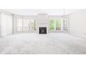 Bright living room with large windows, fireplace, and neutral carpet offering a cozy atmosphere at 244 13Th Ne St # 310, Atlanta, GA 30309
