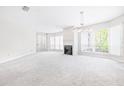 Bright living room with large windows, fireplace, and neutral carpet offering a cozy atmosphere at 244 13Th Ne St # 310, Atlanta, GA 30309