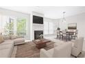 Bright living room featuring a fireplace, modern furnishings, and large windows at 244 13Th Ne St # 310, Atlanta, GA 30309