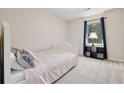 Cozy bedroom features a bed, a window, and soft carpet at 2831 Pine Log Way, Buford, GA 30519