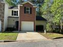 Charming townhome featuring brick accents, well-kept landscaping, and a convenient single-car garage at 2939 Stonecrest Ln, Lithonia, GA 30038