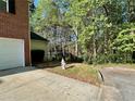 Side yard with driveway, a fire hydrant and mature trees at 2939 Stonecrest Ln, Lithonia, GA 30038