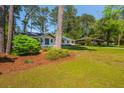 Well-manicured front lawn of white brick home showing mature trees and neighboring home at 3365 Ardley Sw Rd, Atlanta, GA 30311