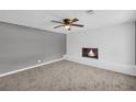 Relax in the living room, featuring a fireplace and ceiling fan at 4301 Hidden Valley Rd, Decatur, GA 30035