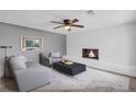 Cozy living room featuring a fireplace, ceiling fan, and comfortable seating arrangement at 4301 Hidden Valley Rd, Decatur, GA 30035