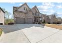 Charming two-story home with brick and stone exterior, well-maintained lawn, and attached two-car garage at 4466 Woodland Bank Blvd, Buford, GA 30518