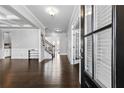 Bright living room boasting hardwood floors, elegant trim, and open layout with ample natural light at 4466 Woodland Bank Blvd, Buford, GA 30518
