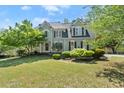 Charming two-story home with a well-maintained lawn and mature trees at 5381 Fawn Meadow Ln, Powder Springs, GA 30127