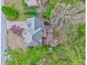 Aerial view of a well-maintained home with a spacious deck surrounded by lush greenery at 4327 Saint Michaels Dr, Lilburn, GA 30047