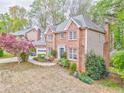 Two story brick home with beautifully manicured landscaping and attached two car garage at 4327 Saint Michaels Dr, Lilburn, GA 30047
