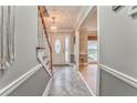 Welcoming foyer with decorative tile flooring and access to the staircase and dining room at 4327 Saint Michaels Dr, Lilburn, GA 30047