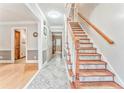 Inviting foyer with hardwood floors, elegant staircase, and neutral wall colors at 4327 Saint Michaels Dr, Lilburn, GA 30047