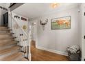Open foyer featuring hardwood floors, staircase and decorative artwork that adds a touch of elegance at 503 Duke Dr, Marietta, GA 30066