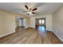 Open-concept living area showcasing wood-look floors, neutral walls, and a ceiling fan at 955 Laurel Mill Dr, Roswell, GA 30076