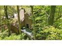 An aerial view shows the deck of the house surrounded by lush greenery at 2451 Cedar Fork Trl, Marietta, GA 30062