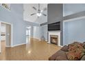 Open living room with vaulted ceilings, fireplace, ceiling fan, and neutral-toned walls at 5013 Centennial Commons Nw Dr, Acworth, GA 30102