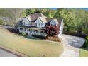Expansive property featuring a well-manicured lawn, inviting front porch, and long driveway at 60 Bartlett Way, Dallas, GA 30157