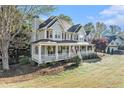 Charming two-story house featuring a welcoming front porch, traditional design, and a well-kept lawn at 60 Bartlett Way, Dallas, GA 30157