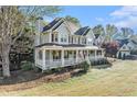 Attractive two-story home featuring a spacious porch, a well-kept lawn, and beautiful landscaping at 60 Bartlett Way, Dallas, GA 30157