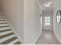 Inviting foyer with a staircase, light gray walls, and a door to the exterior at 116 Winsome Way, Woodstock, GA 30188