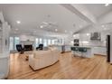 Open-concept living room with a fireplace, kitchen, and hardwood flooring at 1802 N Akin Ne Dr, Atlanta, GA 30345