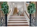 Inviting foyer showcasing a grand staircase with hardwood and carpet, and elegant decorations at 3663 Brookhaven Manor Ne Xing, Atlanta, GA 30319