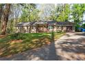 A cozy, one-story house with a welcoming porch and a well-maintained lawn at 1441 Cahaba Sw Dr, Atlanta, GA 30311