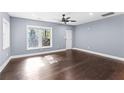 This large living room features hardwood floors, a ceiling fan, and lots of natural light at 1441 Cahaba Sw Dr, Atlanta, GA 30311