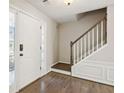 Bright foyer showcasing hardwood floors, a staircase, and a decorative front door at 2500 Kingsbrooke Ln, Duluth, GA 30097