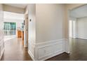 Hallway with hardwood floors leading to an open layout and an outdoor patio at 2500 Kingsbrooke Ln, Duluth, GA 30097