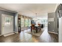 Open-concept dining area with a chandelier, lots of natural light, and views into the modern kitchen at 537 Craven Rd, Roopville, GA 30170