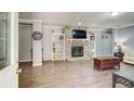 Spacious living room with a stone fireplace, built-in shelving, and warm wood-look flooring, offering a cozy atmosphere at 537 Craven Rd, Roopville, GA 30170