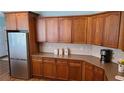 Classic kitchen with wood cabinetry and stainless steel refrigerator at 4118 Sandy Branch Dr, Buford, GA 30519