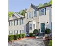 Inviting townhouse with stone facade, green shutters, and manicured landscaping enhancing curb appeal at 2557 Summit Cove Dr # 128, Duluth, GA 30097