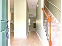 Welcoming foyer featuring hardwood floors, staircase, and a glimpse into the living spaces at 2557 Summit Cove Dr # 128, Duluth, GA 30097
