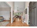 Inviting foyer with hardwood floors, a staircase, and views into the living room at 3665 Evonvale Gln, Cumming, GA 30041