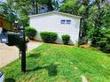 A charming home with a green lawn, mailbox, and mature trees at 3735 Fir Dr, Buford, GA 30518